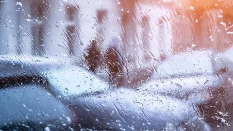 Snow-covered windshield from inside the car. Winter concept Stock Photos