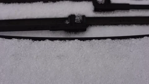 Snow covered windshield with wiper blades. Frozen snow on car in cold winter Stock-Footage 149044312