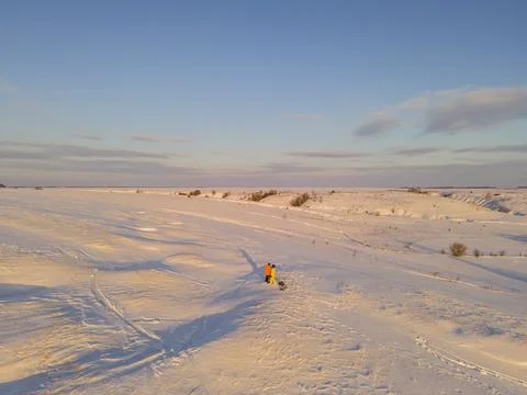 Snow-covered winter fields in the cold in the sun Stock Photos