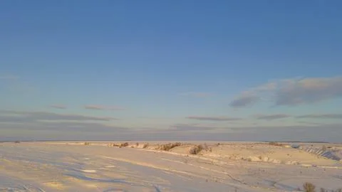 Snow-covered winter fields in the cold in the sun Stock Photos