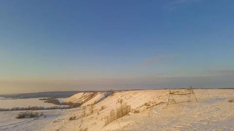 Snow-covered winter fields in the cold in the sun Stock Photos