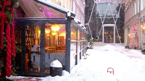 Snow covers bright cafe and historic street Stock Footage 328663152