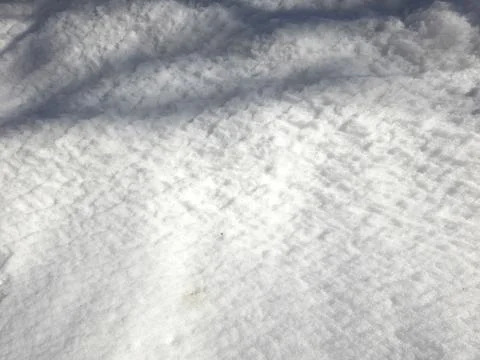 Snow Covers the Ground Showing Texture in the Winter Sunlight During the Da.. Stock Photos