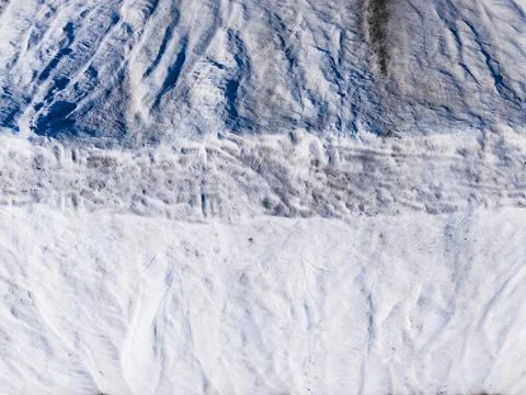 Snow covers a mountain with distinct patterns created by wind and melting. Th Stock Photos