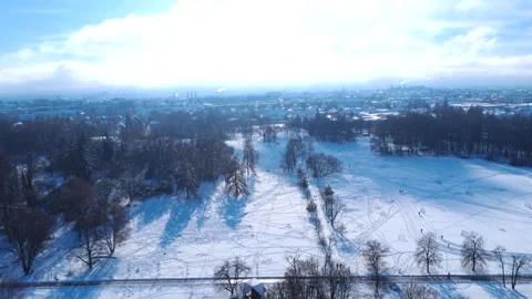 Snow Covers the Park in Winter With Distant City Views and Clear Blue Skies at Stock Footage 327908532