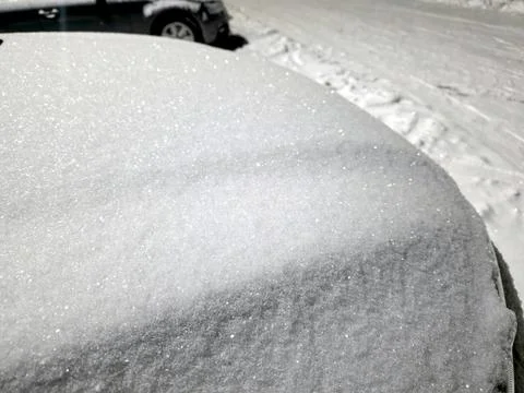 Snow Covers the Surface of a Car Parked on a Street During Winter in a Snow.. Stock Photos