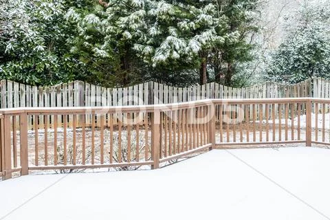 Snow on Deck and Evergreens Stock Photos