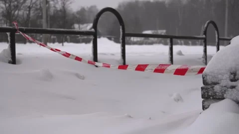 Snow drift blocks walkway and benches indicating safety restrictions Stock Footage 328089406
