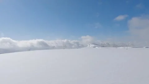 Snow drifting over mountain top winter landscape Stock Footage 245059776