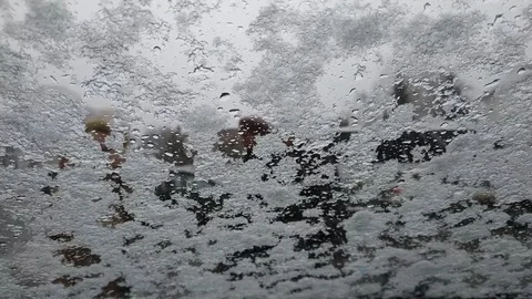 Snow dripping on the windshield of a car Stock Footage