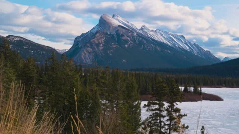A snow dusted Mount Rundle looms over the townsite in Banff National Park Stock Footage 315699231
