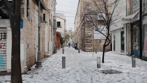 Snow in an empty city. Heavy snowfall in the Jerusalem city. Difficult to walk Stock Footage 170611614