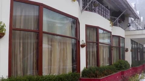 Snow fall during winter with with house in the background 스톡 동영상 148254372