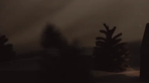 Snow fall on gingerbread house surrounded by fir-trees and snow drifts Stock-Footage 70062602