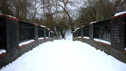 Snow Fall on Park Bridge Walking Across Stock Footage 90265733