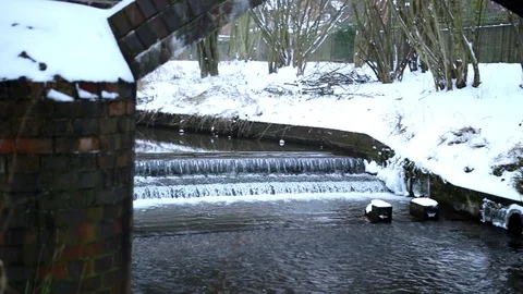 Snow Fall Snowy Bridge and Stream pan from left to right Stock Footage 90286915
