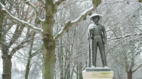 Snow fall on World War One battlefields : Gurkha statue, Ypres, Belgium Stock Footage 102189744