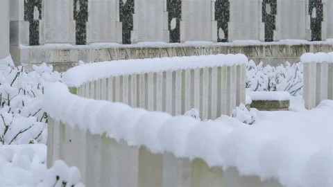 Snow fall on World War One battlefields : Tyne Cot Cemetery, Ypres, Belgium Stock Footage 102202214