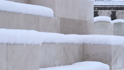 Snow fall on World War One battlefields : Tyne Cot Cemetery, Ypres, Belgium Stock Footage 102207664