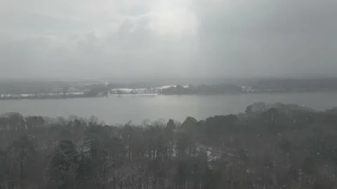 Snow falling along the river Stock Footage 148650316