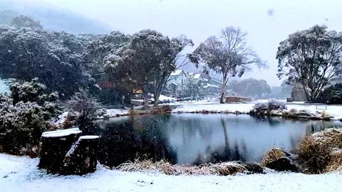 Snow falling in alpine village Stock Footage 276023144