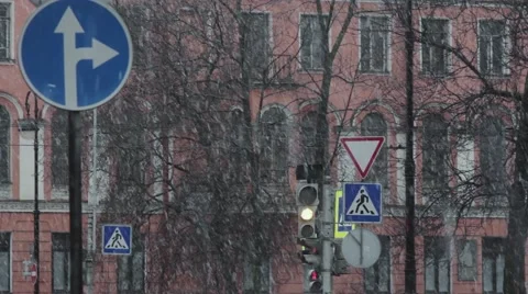 Snow falling and changes to traffic light on the crossroad Stock Footage 63130628