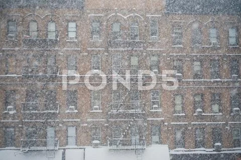 Snow Falling By Apartment Buildings