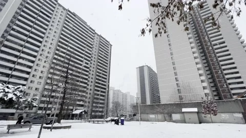 Snow falling on apartment complex Video stock 166122478
