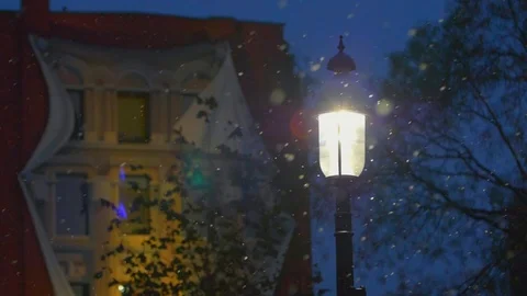 Snow falling around bright light lamp post in winter 01 Stock Footage 99066752