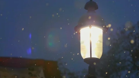 Snow falling around bright light lamp post in winter 04 Stock Footage 99066806