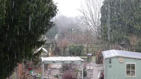 Snow falling in back garden Stock Footage 84945057
