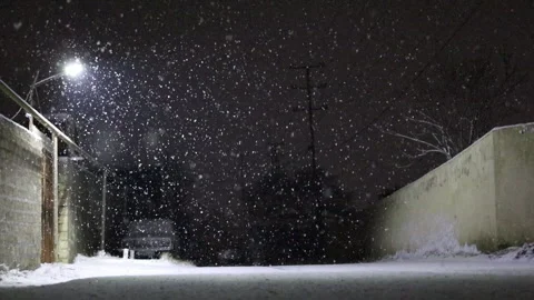 Snow falling in the background of a street lamp. Night time. Stock Footage 304662979