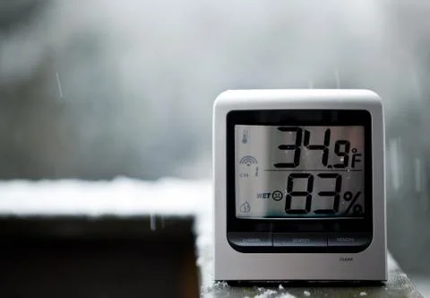 Snow falling behind thermometer Stock Photos