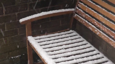 Snow falling on a bench Stock Footage 92480489