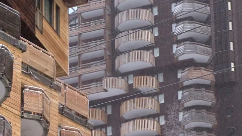 Snow Falling between wooden buildings Stock Footage 303588910