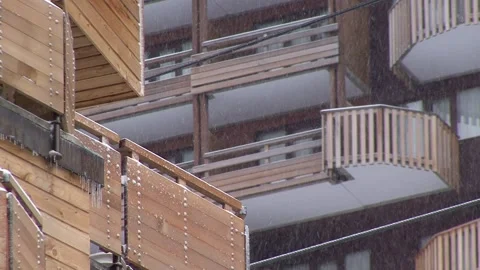 Snow Falling between wooden buildings Stock Footage 303588916
