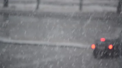 Snow falling on blurred road with moving cars Stock Footage 69071613