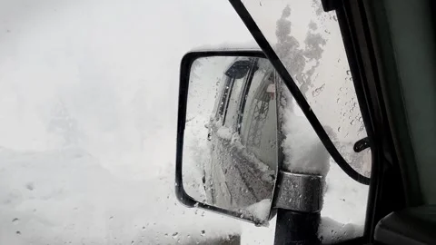 Snow falling on car mirror Stock Footage 280637363