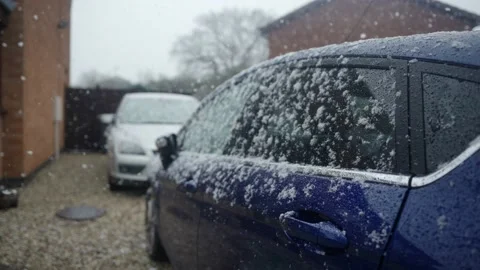Snow falling on car windows in slow motion. Stock Footage 145921651