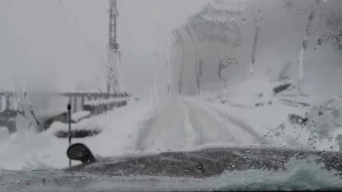 Snow falling on the car windscreen. Car wiper during rain Stock Footage 280637310