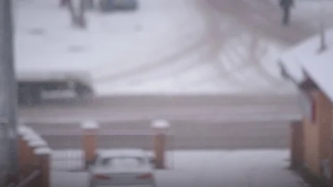 Snow falling in city on background of road Stock Footage 79251245