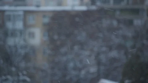 Snow falling in city on blurred background of a building Stock Footage 87900868