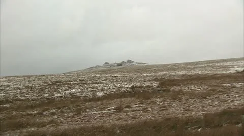 Snow falling on a Dartmoor Tor Video stock 8908943