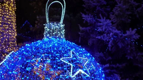 Snow is falling The decorated Christmas tree glows Video stock 227526507
