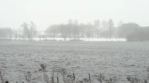 Snow falling down lake mist Stock Footage 148629629