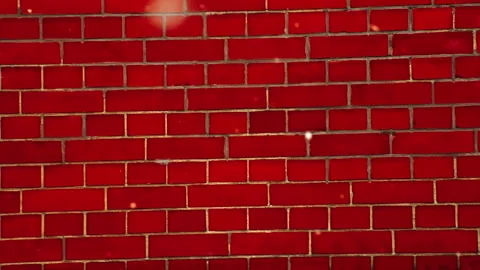 Snow falling down in slow motion in front of a red brick wall Vidéo 268621075