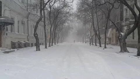 Snow is falling on empty street of old city Stock Footage 142741507