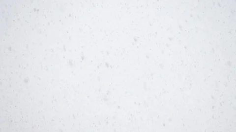 Snow is falling fast against the sky. 動画素材 117896454