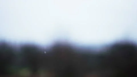 Snow falling in front of a beautiful blurred background Stock Footage 225283680