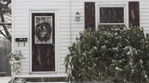 Snow falling on front door of home Stock Footage 33746982